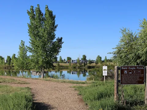 Bald Eagle Pond at St. Vrain State Park in Firestone on an August afternoon, with a campground loop on the far shore under a wide sky